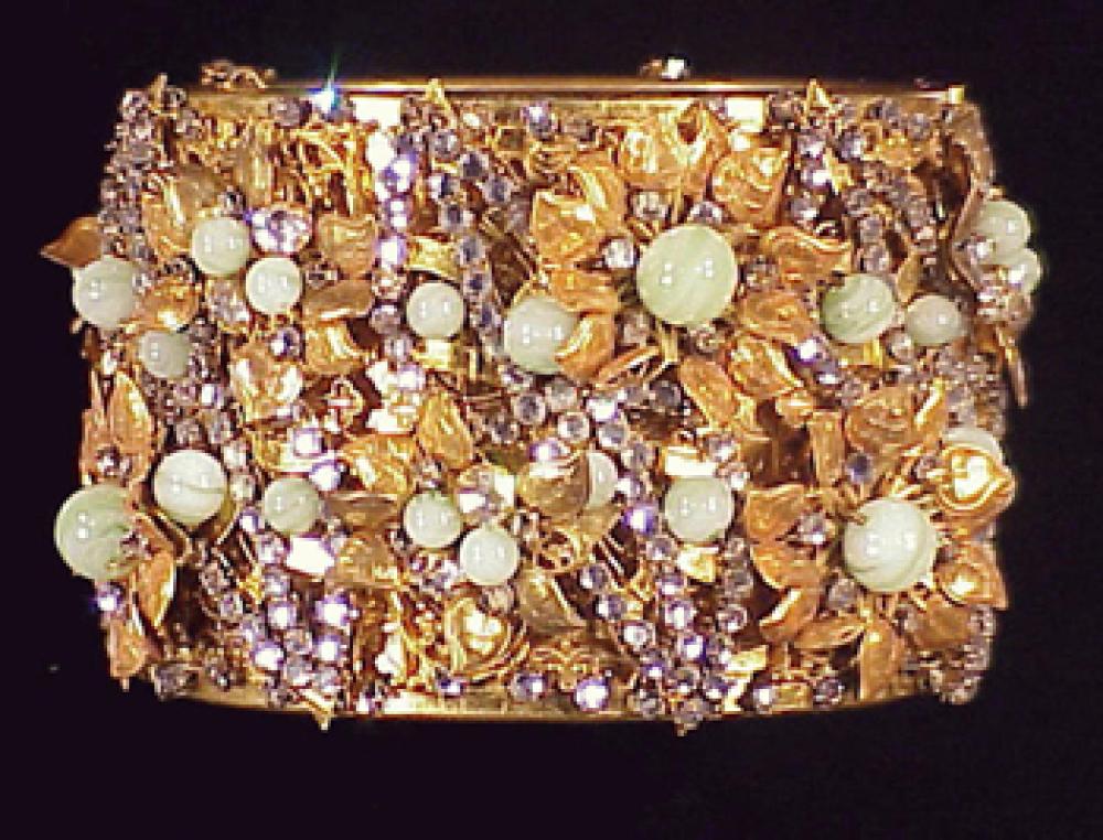 Miriam Haskell Gold Jeweled Hinged Cuff

Lot 242
Miriam Haskell Gold Jeweled Hinged Cuff
 Gilt-metal, cluster set with flowerheads decorated with celadon beads and rhinestones, marked.