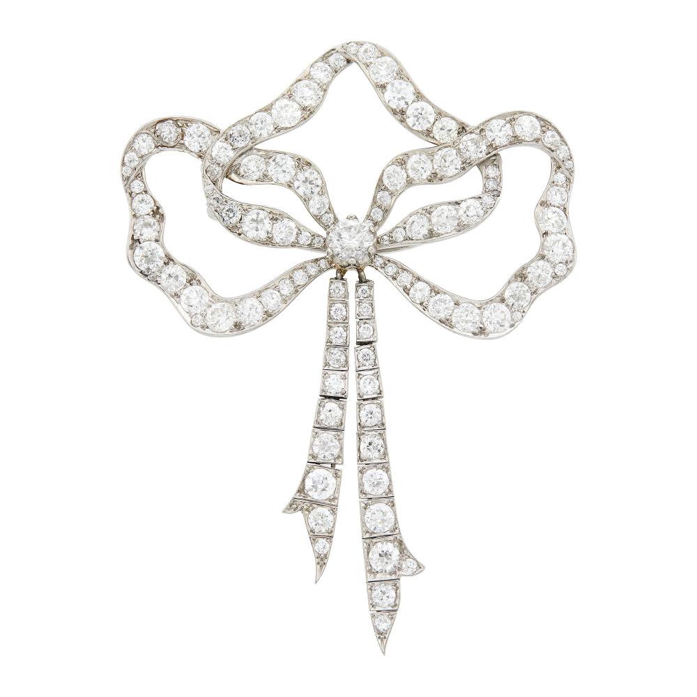 Property from the Collection of Augusta PattonOne old European-cut diamond ap. .45 ct., old European-cut diamonds ap. 5.70 cts., signed Tiffany & Co., center diamond and setting possibly added later, ap. 10.8 dwts.
 
Please note that the bottom ribbons were added later.

Center diamond: H-I-I1.Diamonds: G-H-I-VS.Fringe nicely articulated.Gold solder repair on circle links joining fringe.2 3/4 x 2 inches.                            
Any condition statement is given as a courtesy to a client, is an opinion and should not be treated as a statement of fact and our Organization shall have no responsibility for any error or omission. Please contact the specialist department to request further information or additional images that may be available.