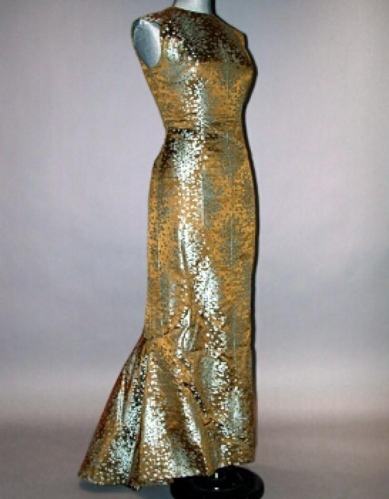 Pauline Trigere Brocade Evening Gown

Lot 563
Pauline Trigere Brocade Evening Gown
 American, circa 1965 
 Sleeveless, princess line, with fishtail train, of olive and robin’s-egg blue abstract floral pattern, size 6, labeled: Pauline Trigere.
Very good condition.