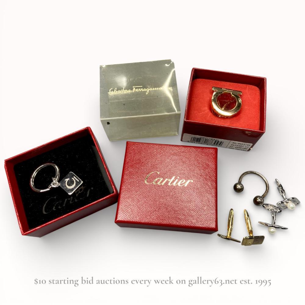 Description
Five-piece assortment of designer menâs accessories including tie pins, cufflinks, and keyring charms. Group featuring mixed metal finishes with polished gold- and silver-tone surfaces. Forms including stirrup motifs, cube charm, circular hardware elements, and bar-style cufflinks. Select pieces presented with branded presentation boxes. Lot offered as a single grouped set.Including all brands pictured in photos. vintage Dior, Cartier, Ferragamo etc.