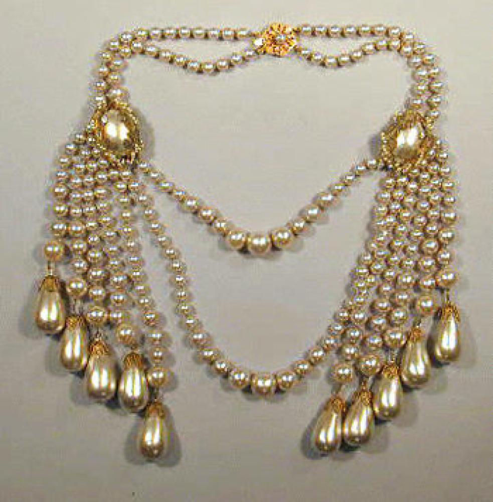 Miriam Haskell Pearl Tassel Necklace 1940s

Lot 240
Miriam Haskell Pearl Tassel Necklace 1940s
 1940s 
 Double strand of pearls with multiple pearl strand tassels on each side, each strand ending with a large teardrop pearl, marked: Miriam Haskell.
Minor discoloration to gilt-metal.