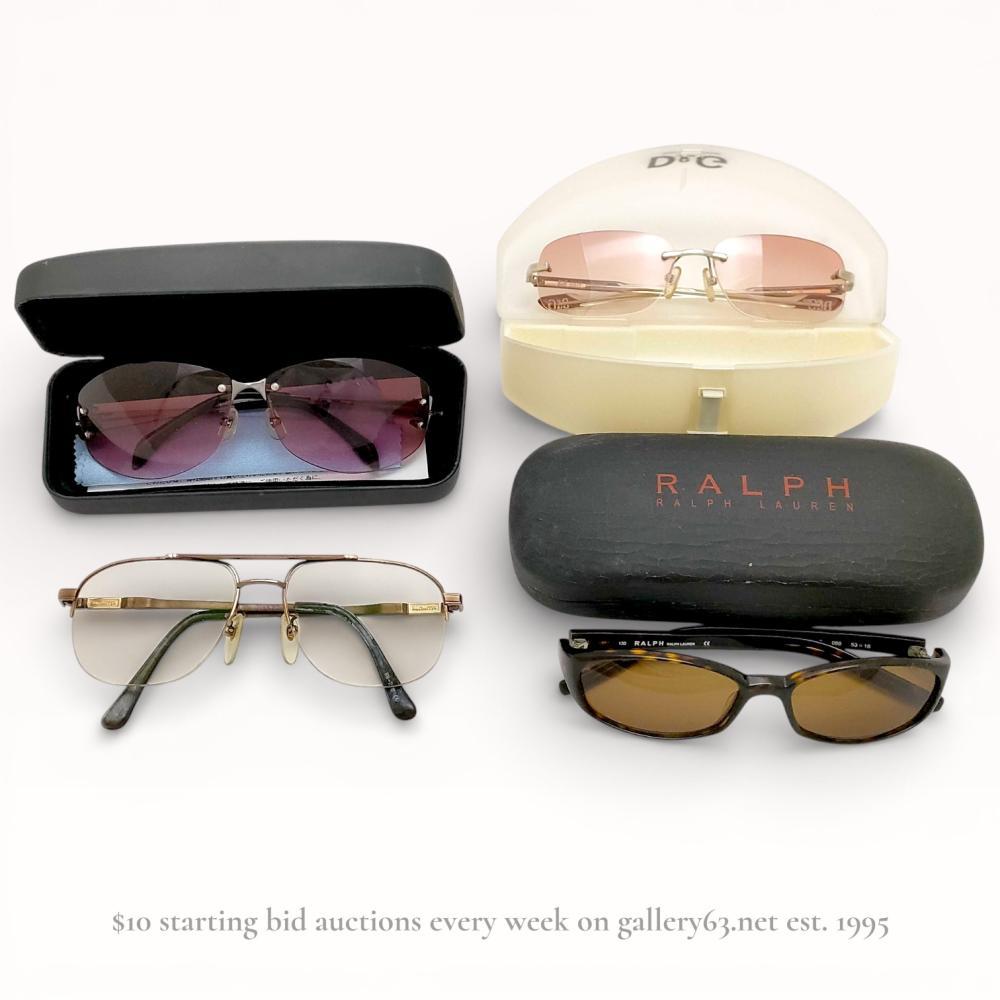 Description
Four pairs of designer sunglasses and eyewear including Katharine Hamnett London, D&G, Barneys New York, and Ralph by Ralph Lauren. The collection features rimless metal frames with gradient lenses, gold-tone half-rim aviators, and full-rim tortoise shell acetate frames. Interior temple markings include KH09-7, D&G on nose pads, and Ralph Lauren model codes 086 53-18. Three pairs are accompanied by original branded hardshell or clamshell cases.
Ralph Lauren frames approximately 5.5 inches width.