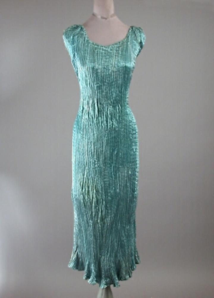 Ballerina Length Fortuny Delphos Dress

Lot 513
Ballerina Length Fortuny Delphos Dress
 Italian, 1930s 
 Teal/aqua blue, with tan Venetian glass beads at armscyes, bateau neckline on elastic, labeled in selvage: Made In Italy/Fabrique en Italie/Fortuny/depose.
Good condition, areas of loosened pleats, minor discolorations, especially at armscyes.