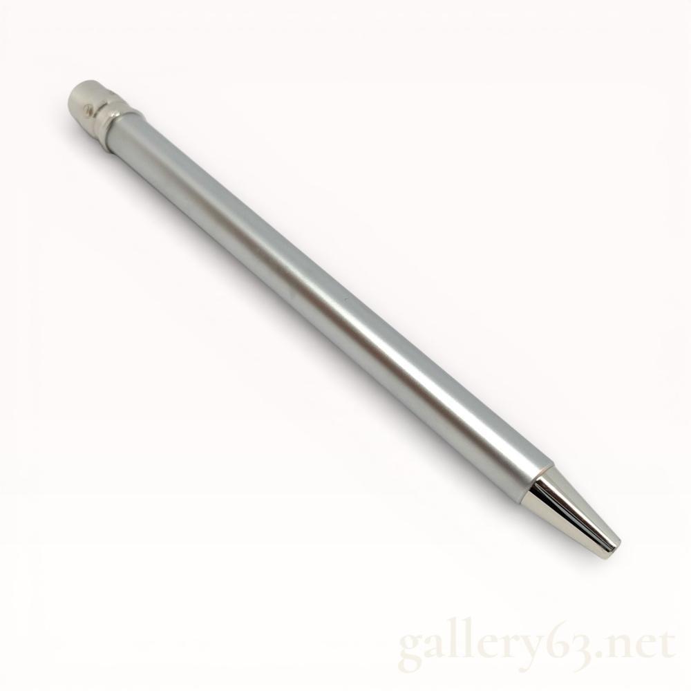 Description
Cartier Must de Cartier Santos ballpoint pen, late 20th century. The writing instrument is crafted from brushed silver-tone metal with a polished clip featuring the signature Santos screw-head motif. The cap top is engraved with the Cartier script logo, and the cap ring displays a stylized C emblem. Accompanied by a red Cartier presentation box with gold-tooled garland border and a Cartier M 212 refill.