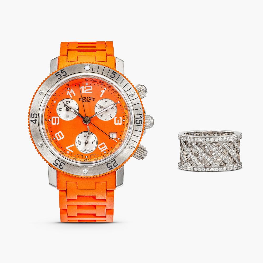 Hermès

Comprising: ring of openwork design, decorated with brilliant-cut diamonds; wristwatch with circular dial, completely by a orange rubber strap.
