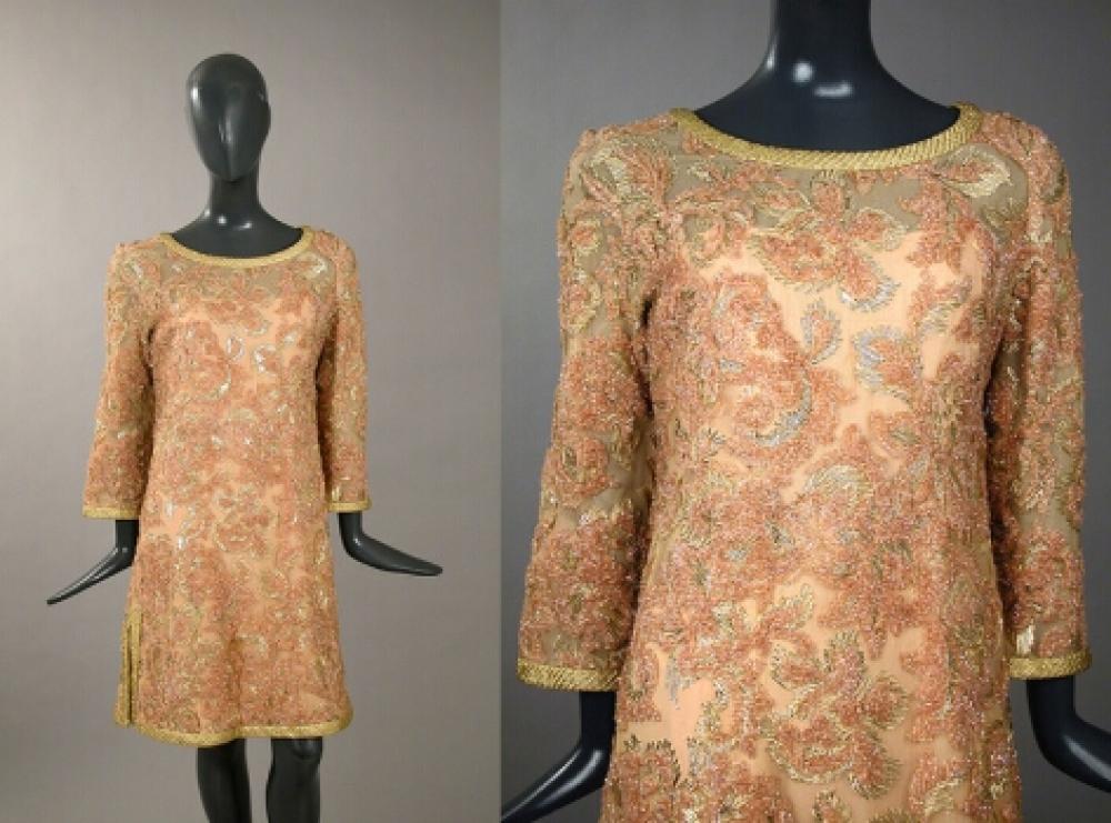 Balmain Gilt and Blush Pink Cocktail Dress Galante

Lot 542
Balmain Gilt and Blush Pink Cocktail Dress Galante
 French, 1967 
 Of blush net worked with chenille and gold metallic threads, A-line, with flared long sleeves and gold braid trim at all edges, size 6-8, labeled: Pierre Balmain/Paris and tape label no.: 142560.
Very good condition.
 With original bill of sale.