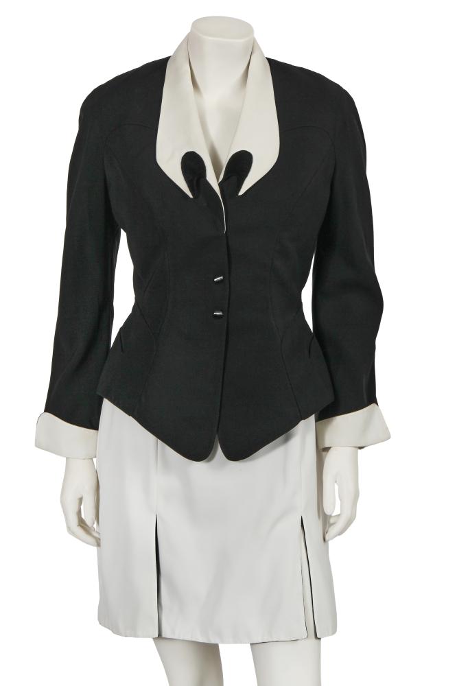 A Thierry Mugler black and white gabardine suit, circa 1990

A Thierry Mugler black and white gabardine suit, circa 1990

labelled size 42, the jacket with pronounced notched collar and curved cuffs, popper fastened, cut-outs to the hip pockets, bust approx 91cm 36in, the matching short white skirt with black godets, waist 69cm 27in (2)

Share this lot: