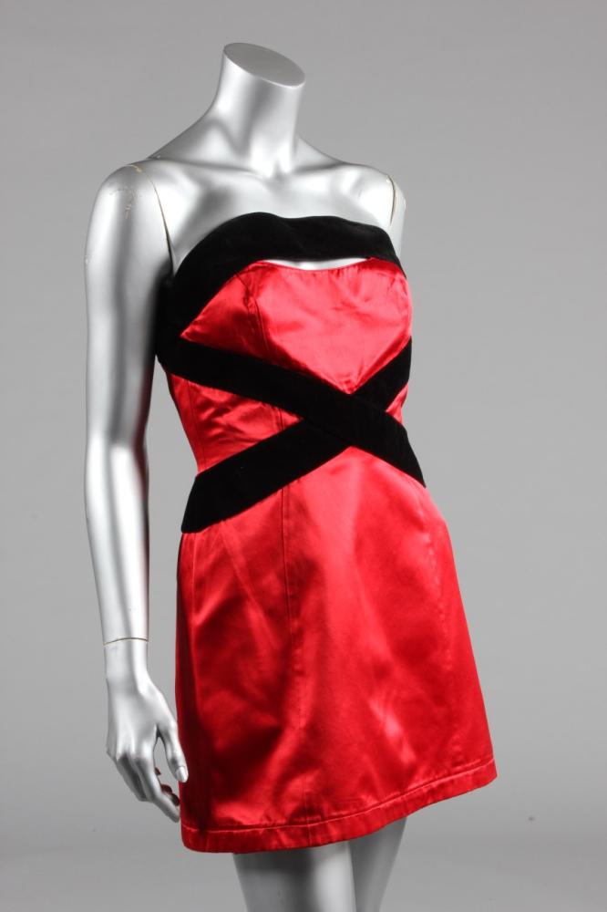 

A Thierry Mugler red satin cocktail dress, 1990s, blue label and size 40, with boned integral corset, black velvet bands criss cross the bodice, bust 86cm, 34in
