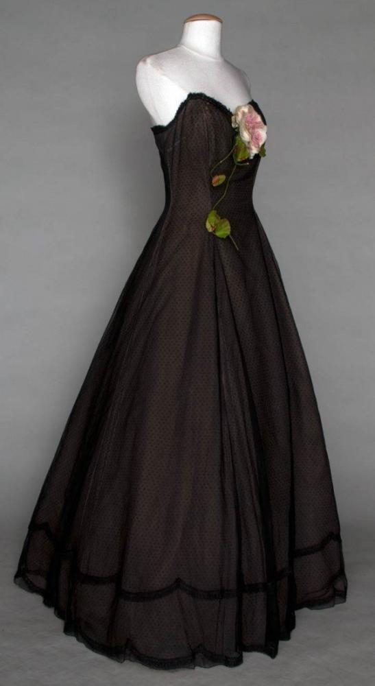 DIOR COUTURE BALLGOWN, AUTOMNE-HIVER 1955

Strapless, sheer black silk, princess line, bell-shape skirt, pink cloth rose & stem, 10 layers (6 silk, all damaged) top-bottom: 1) black leno weave, lace trim (back skirt holes, 1" tear above breast