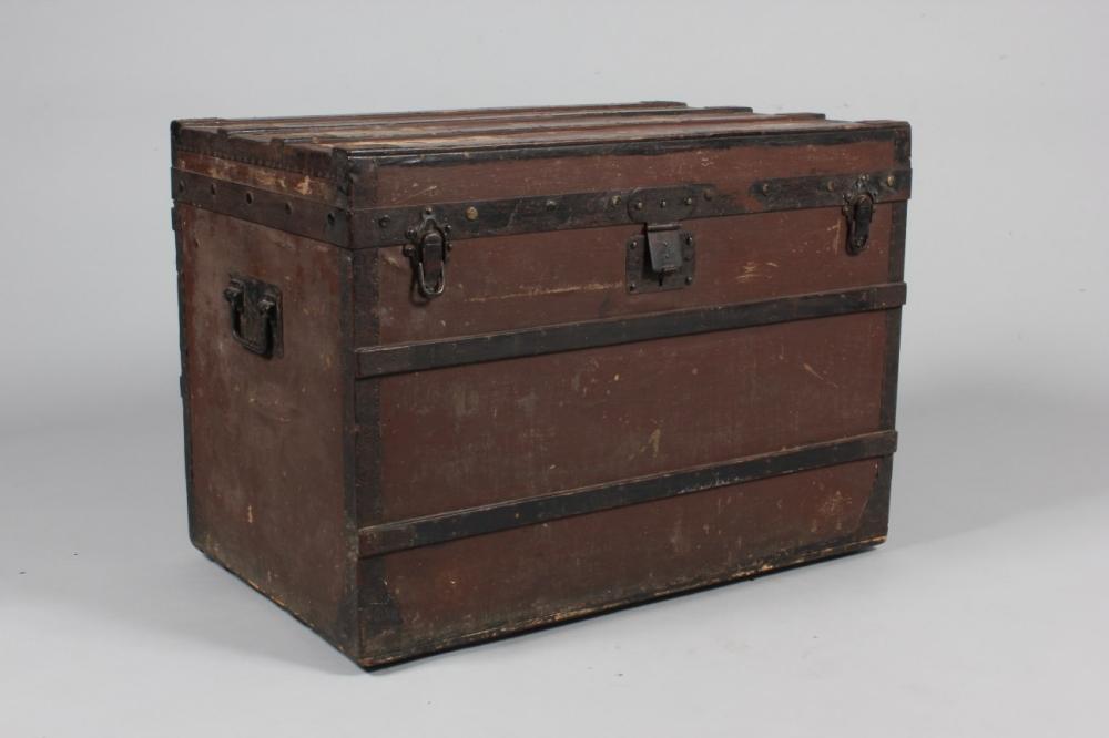 

A Louis Vuitton trunk, circa 1885, the exterior of brown canvas with metal and wooden struts and rivets, faintly initialled in black to the lid, the interior lined with striped paper and with large printed LV trunk label numbered 22298, and bearing 289 Oxford St, Regent Circus, and Rue Scribe Paris addresses, on small wheels, carrying handles to the sides, 58 by 80 by 51cm; 23 by 37 1/2 by 20in



The large trunk trade label was only used between 1885 and 1890.
