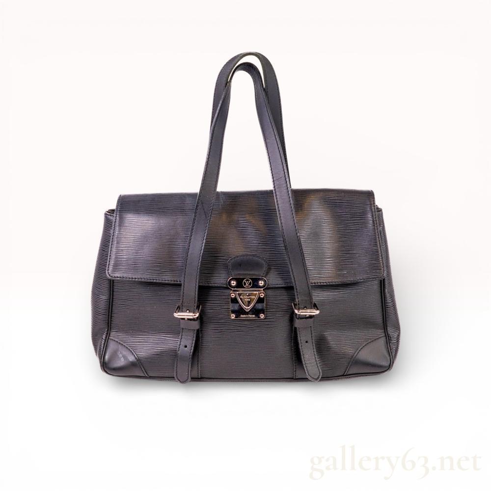 Description
Louis Vuitton Segur MM shoulder bag in Noir Epi leather. This structured bag features a top flap with a silver-tone metal S-lock closure and two adjustable flat leather shoulder straps secured by buckles. The exterior includes a large rear slip pocket and smooth leather corner patches, with a tonal textile-lined interior. Hardware is stamped with the LV logo and LOUIS VUITTON PARIS made in France; interior leather patch bears the brand heat stamp.
Height: 11 inches
Width: 11.5 inches
Depth: 3.5 inches.
