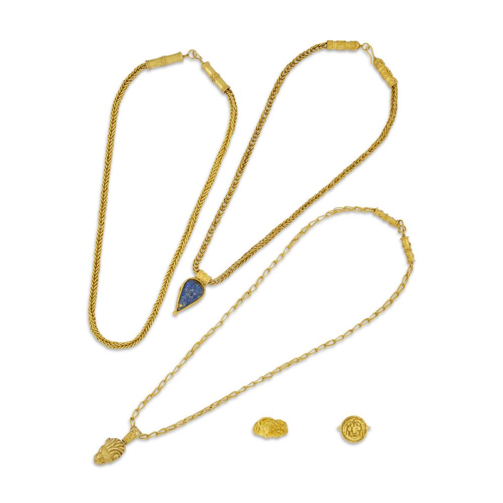 GROUP OF ANTIQUE GOLD JEWELS

Comprising one gold necklace, one gold necklace with a pendant depicting a woman and a lion, one gold necklace set with a cabochon lapis lazuli in a closed-back setting, one gold ring depicting a lion, and one gold ring depicting a ram 
18k yellow gold, 19th century 
Size/Dimensions: first necklace 47.5 cm long; second necklace with pendant 51.0 cm long; third necklace with lapis lazuli pendant 44.0 cm long; ring with lion EU ring size 52¹⁄₂ / US ring size 6; ring with ram EU ring size 59 / US ring size 9 
Gross weight: 157.9 grams