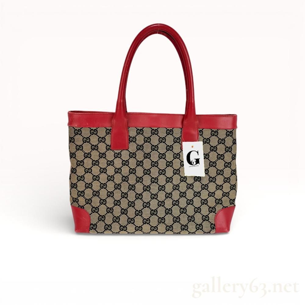 Description
Authentic Gucci GG Canvas Tote with Red Leather Trim. Gucci tote constructed in GG monogram canvas featuring red leather trim throughout. Structured silhouette with dual leather top handles and reinforced leather corners. Open-top design with fabric-lined interior suitable for daily use.