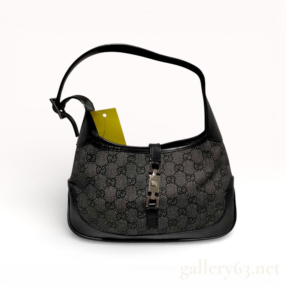 Description
Gucci Jackie hobo-style shoulder bag featuring black GG monogram denim-style canvas with smooth black leather trim. The exterior is detailed with silver-tone hardware and the signature piston-lock closure. The interior is lined in black textile with a single zippered pocket and a leather brand tab stamped GUCCI made in Italy.
Width: 10.5 inches
Height: 6.5 inches
Depth: 1.5 inches
Strap Drop: 8 inches.