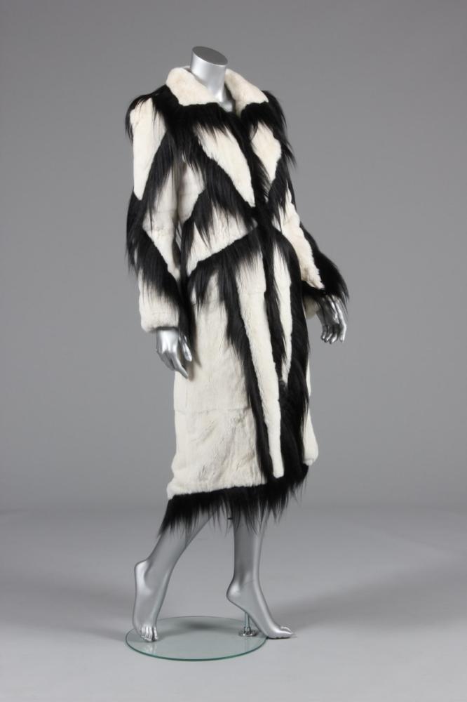 

A striking Thierry Mugler white fur coat, early 1990s, blue couture label, the white fur with criss-cross lattice of black fur, pointed rear tails, chest 92cm, 36in
