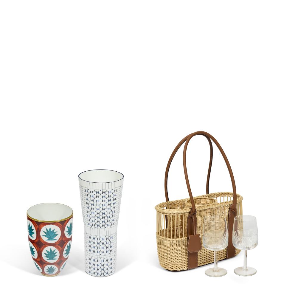 A GROUP OF THREE: A HAND-PAINTED PORCELAINE DUNE VASE, A BLEU ENCRE PORCELAINE CANOPÉE SON DU H GM VASE & A GOLD TAURILLON LEATHER & OSIER PARK BOTTLE BASKET WITH TWO INTERVALLE CRYSTAL WINE GLASSES