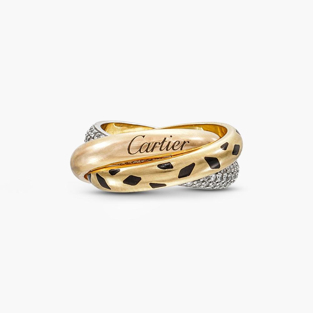 Cartier

Designed as three interlocking rings, one pavé-set with brilliant-cut diamonds, and one decorated with black lacquer spots.