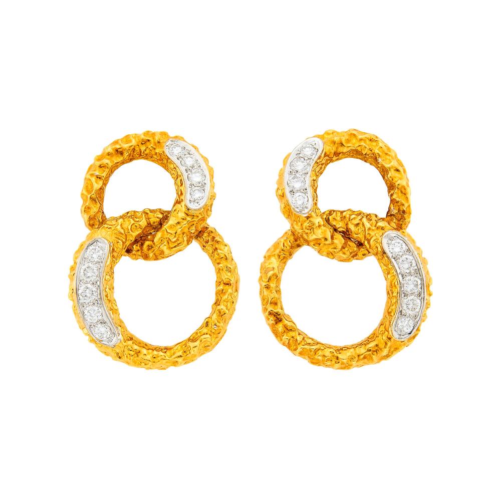 Property of a Distinguished Lady from Athens, Greece18 kt. yellow and white gold, 18 round diamonds ap. 1.25 cts., signed Vourakis, r.73, ap. 19.5 dwts.

Diamonds: G-H-I-VS.Rosy patina to gold.Clip-backs. 1 1/2 x 1 1/16 inches.                            
Any condition statement is given as a courtesy to a client, is an opinion and should not be treated as a statement of fact and our Organization shall have no responsibility for any error or omission. Please contact the specialist department to request further information or additional images that may be available.
