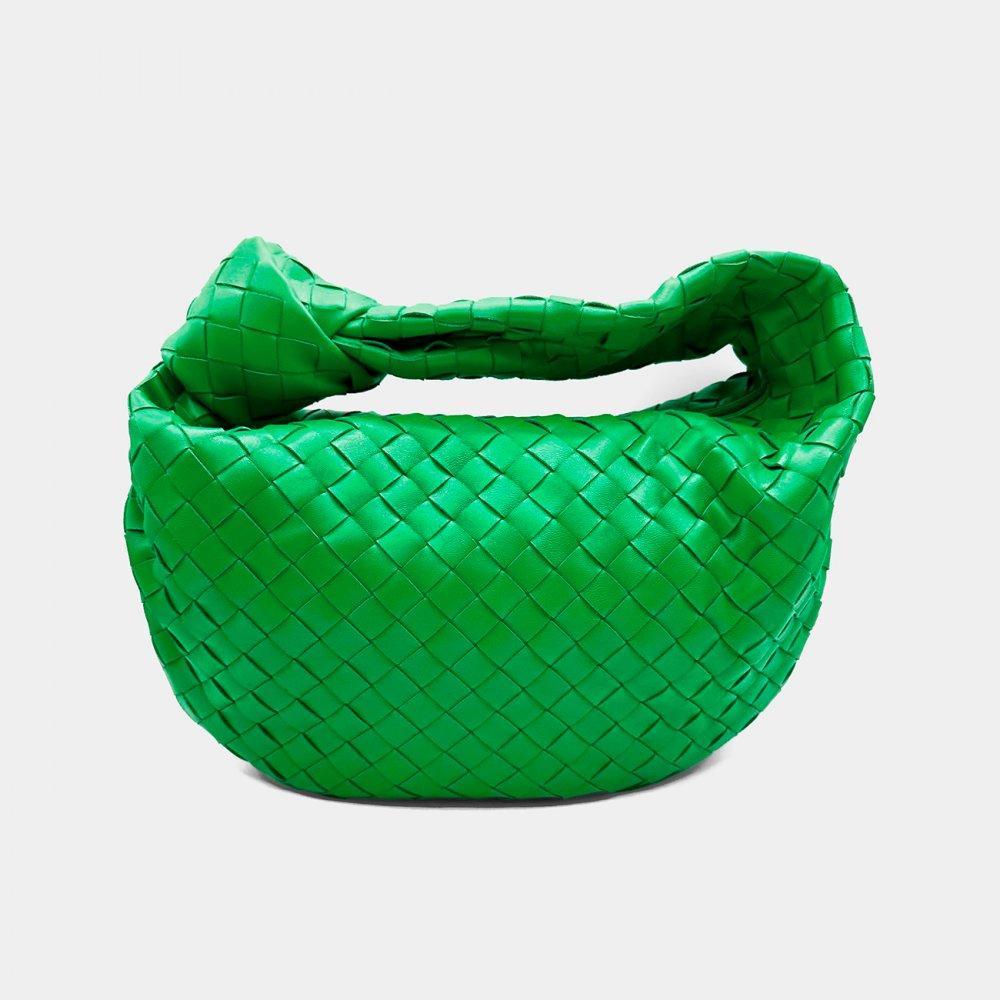 Description

BOTTEGA VENETA.
Jodie bag.
Made in green Intrecciato leather. With a single compartment, green interior. Zipper closure. Top handle with emblematic knot.
Very good condition. Comes with dustbag.
Measurements: 22 x 36 x 6 cm.

Italian brand Bottega Veneta was founded by Michele Taddei in 1966, when the company began producing handcrafted leather goods. The firm created the design made with interlocking leather, "Intrecciato", offered on most of its luxury handbags. The term "intrecciato" refers to the signature weaving technique for which the brand is famous. Highly skilled artisans weave strips of shaped leather by hand in a tight, intricate pattern, creating a unique and durable texture.