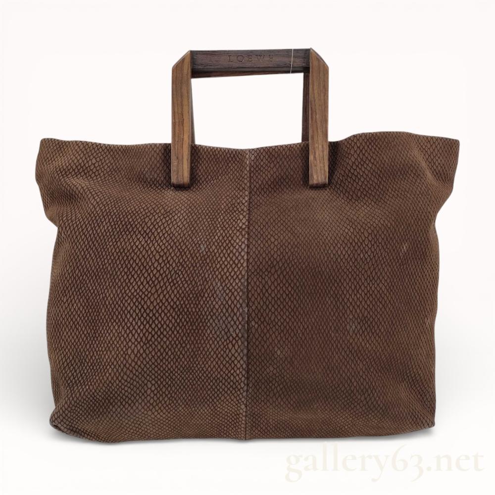 Description
Authentic rare and vintage Loewe brown python leather handbag with mahogany wood sculpted modernist handles. This bag can not be purchased anywhere online besides Gallery 63. I have looked for a comparable, they were all thousands of dollars many years ago. This is a rare vintage bag that seems to trade almost never. Now is your opportunity to get an incredible bag at a great value at Gallery 63. THIS BAG CAN NOT BE SHIPPED INTERNATIONALLY