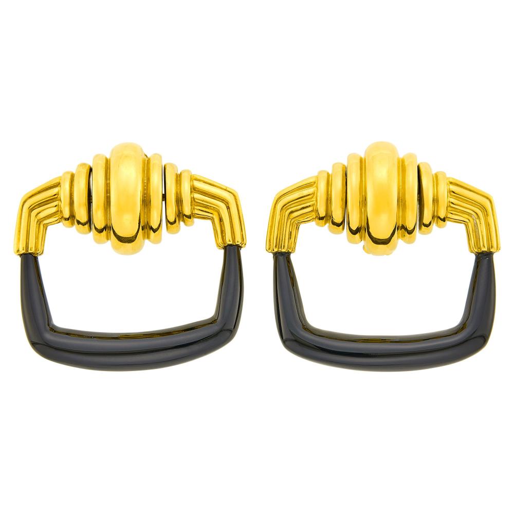 Estate of a Florida Lady18 kt., signed Aldo Cipollo, Cartier, no. 22172, 1971, ap. 24.5 dwts. gross.

Clip-backs. 1 1/4 x 1 1/2 inches.                            
Any condition statement is given as a courtesy to a client, is an opinion and should not be treated as a statement of fact and our Organization shall have no responsibility for any error or omission. Please contact the specialist department to request further information or additional images that may be available.