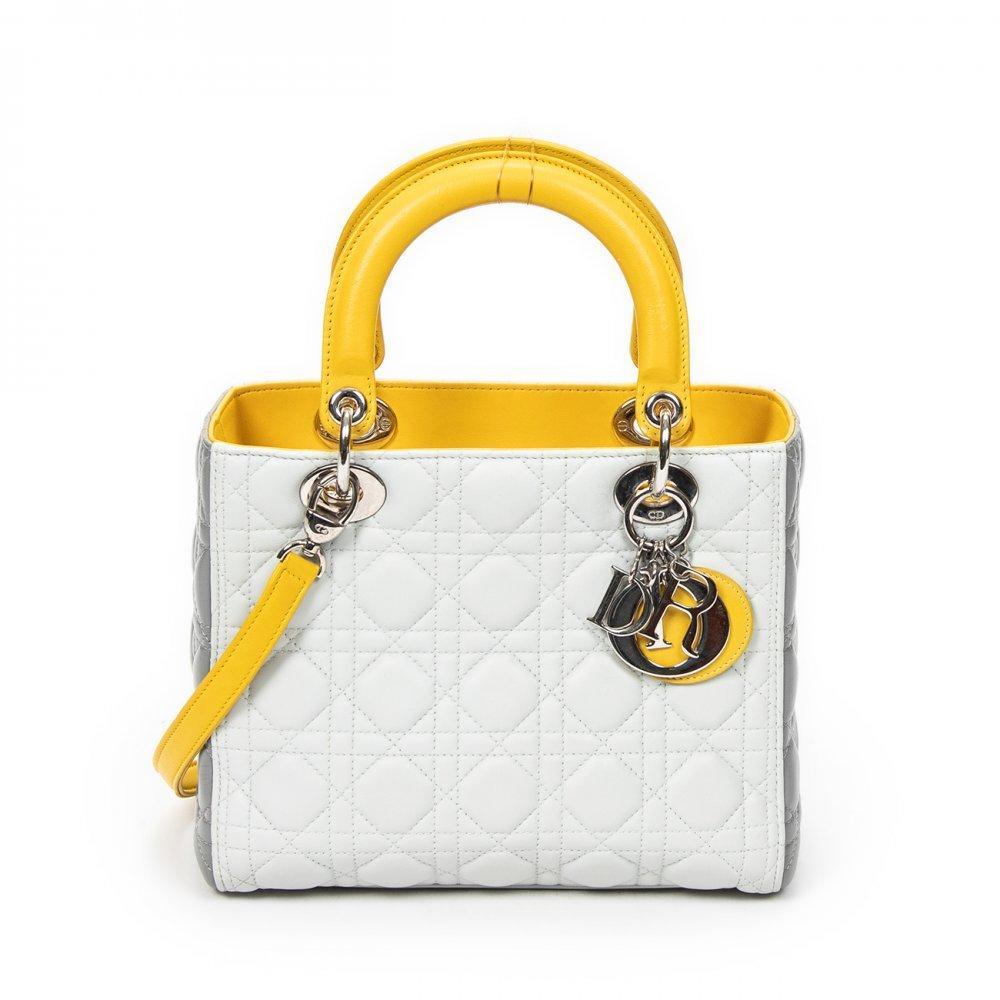 Description

DIOR.
Medium Lady Dior Zip bag.
White and grey leather on the sides, with the iconic "cannage" stitching and yellow leather for the handles and the inside of the bag. Silver hardware. D.I.O.R. charms. Double short top handle. Long removable shoulder strap. Zipper closure.
Includes removable handle and charm.
With interior numbering.
In excellent condition, light signs of use.
Measurements: 24 x 20 x 11 cm.

The Lady Dior is, without a doubt, one of the most emblematic bags in the history of fashion. Launched in 1994 under the original name "Chouchou", its destiny changed in 1995. It was then that Bernadette Chirac, First Lady of France, gave it as a gift to Princess Diana of Wales during her visit to Paris. Diana Spencer’s love affair with the bag was instantaneous; from that moment on, the princess wore it assiduously on her travels around the world, consolidating its popularity. Given the resounding success of the bag when it arrived in boutiques in January 1996, the Maison decided to officially rename it Lady Dior, an enduring tribute to the iconic Princess of Wales. This coveted accessory comes in a wide variety of materials, ranging from soft lambskin or patent calfskin, to more exotic options such as deerskin, smooth leather, grained leather, crocodile skin, canvas or python skin, among others. Each Lady Dior piece is a handcrafted work of art, requiring the meticulous work of seven craftsmen and a minimum of eight hours of manufacturing. For its elaboration, about 130 pieces must be delicately cut and sewn by hand, which underlines its exclusivity and the mastery behind its creation.

With interior numbering. In excellent condition, slight signs of use.