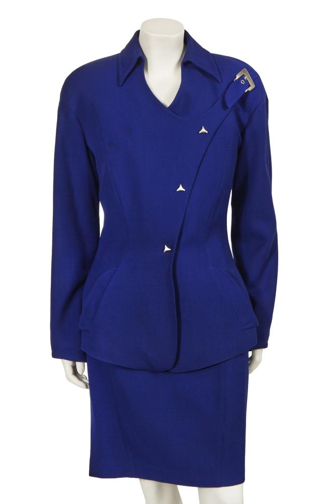 A Thierry Mugler electric blue wool suit, circa 1993

A Thierry Mugler electric blue wool suit, circa 1993

Activ labelled, size 46, the jacket with lightly padded shoulders, asymmetric front closure, silver-tone buckle to the left shoulder, curved triangular press-studs, angled collar, curved pockets, bust 97cm 38in; the matching skirt with curved waistband, waist 76cm 30in (2)

Share this lot: