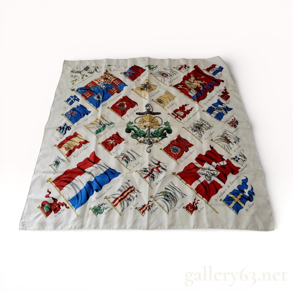 Description
Hermes silk twill scarf in the Pavois pattern, originally designed by Philippe Ledoux in 1964. The maritime-themed design features a central anchor and shell motif surrounded by various historical naval flags and ensigns on a cream ground. Finished with a traditional hand-rolled and hand-stitched hem, the piece includes printed marks for Hermes Paris, Pavois, and Ledoux.
Approximately 35 x 35 inches.
