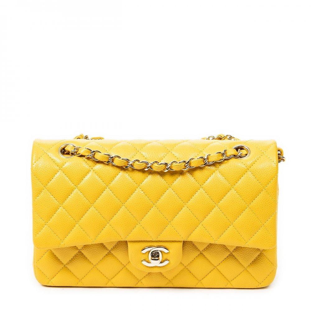 Description

CHANEL
Classic Double Flap 26 bag.
Made in lambskin leather in yellow tone, with diamond quilting (matelassé) and soft touch finish. Structured design with double flap, metallic turn-lock with gold interlaced CC logo. Long metal chain handle intertwined with tone-on-tone leather, suitable for shoulder or cross-body carry.
Includes sticker and dust bag.
With interior numbering.
In perfect condition, barely unused. Small dirt stains on the leather of the front buckle.
Measurements: 25,5 x 16 x 7,5 cm.


The Classic Double Flap is one of the undisputed icons of CHANEL, a symbol of timeless elegance and craftsmanship excellence. This modern reinterpretation of the 2.55 model, with the CC Turn Lock clasp introduced by Karl Lagerfeld, combines tradition and contemporary style.
Since its founding by Gabrielle "Coco" Chanel, the Parisian maison has marked the history of fashion with iconic creations that transcend time and define modern luxury.

With interior numbering. In perfect condition, barely unused. Small dirt stains on the leather of the front buckle.