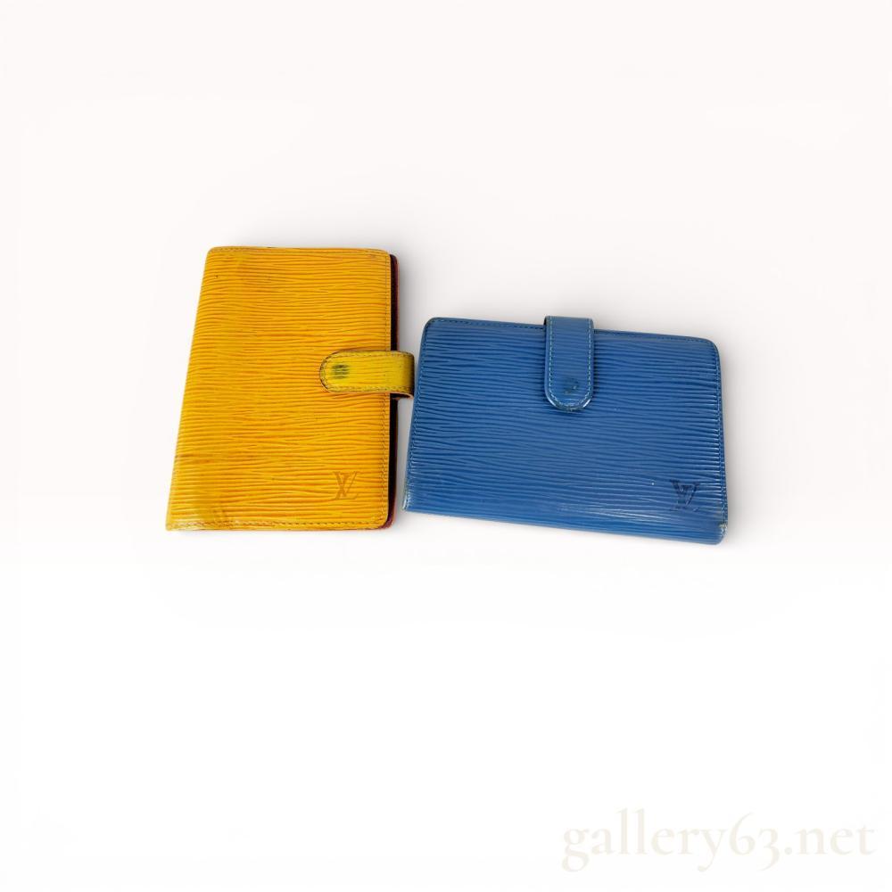 Description
Louis Vuitton small leather goods crafted in signature textured Epi leather. The lot includes a Tassil Yellow Agenda PM with a purple cross-grain leather interior and a blue Portefeuille Viennois French wallet with a kiss-lock coin compartment. Both items feature gold-tone hardware, embossed LV logos, and interior brand stamps indicating manufacture in Spain and France.
Yellow Agenda: 5.75 x 4 inches
Blue Wallet: 5.3 x 3.5 inches.